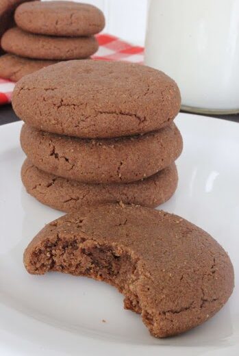 Four ingredient chocolate peanut butter cookies on a plate with a bite taken out of 1