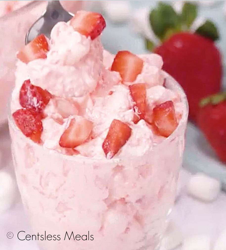 Strawberry fluff salad in a clear dish with a spoon