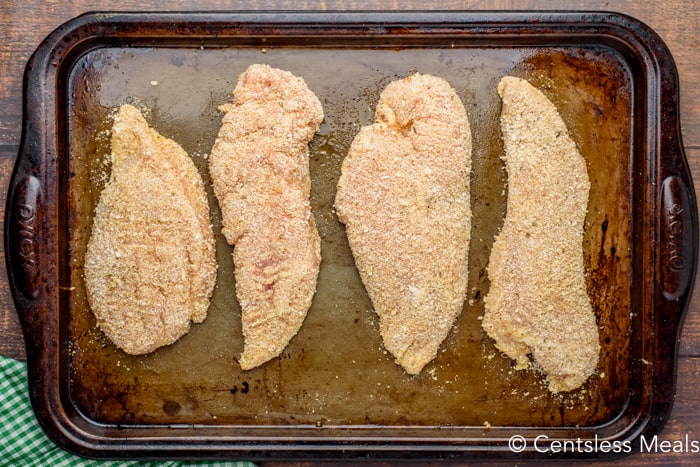 Coated chicken on a baking sheet