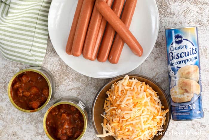 Ingredients for chili cheese dog bake on a marble board