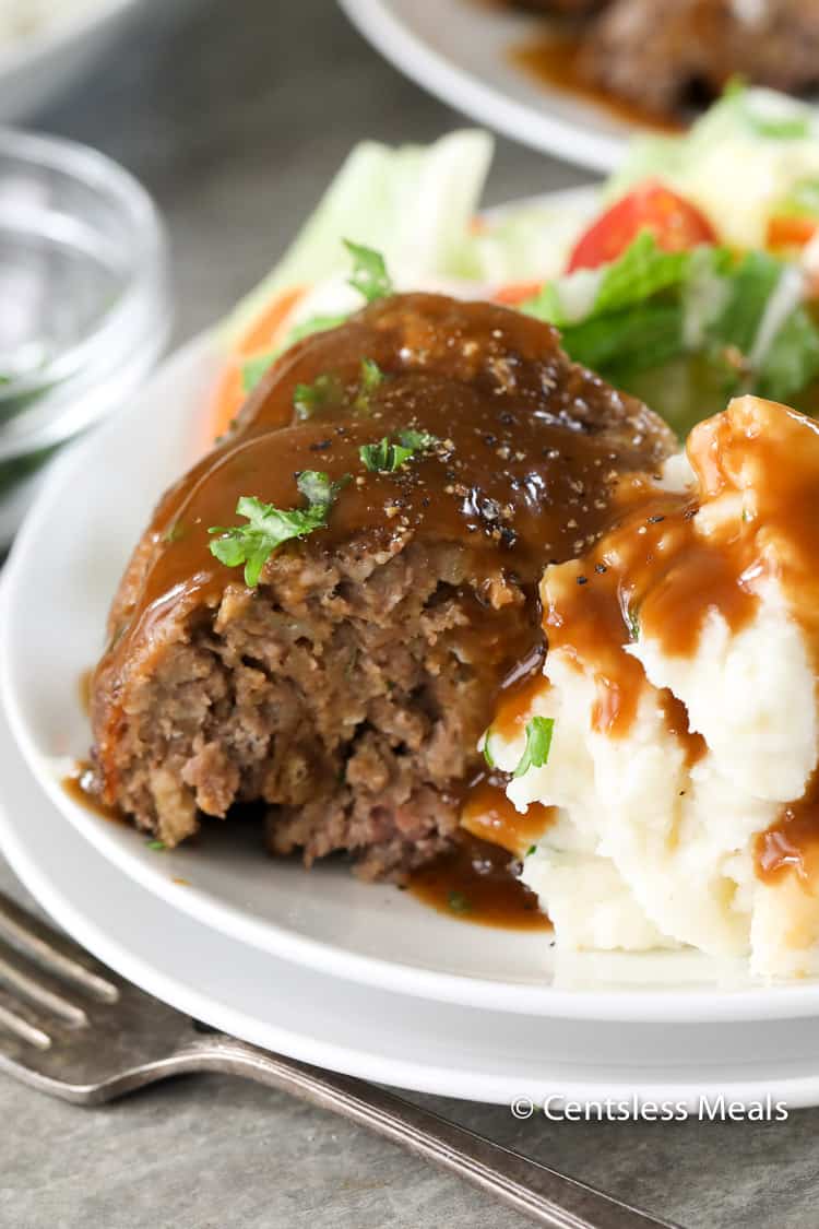 Stove top meatloaf on a plate with mashed potatoes and parsley
