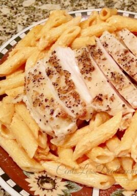 Tomato Cream Sauce Pasta with Grilled Chicken on a plate