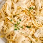Cajun chicken alfredo in a bowl garnished with parsley