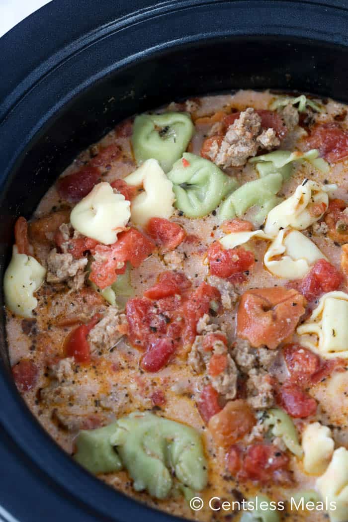 Creamy tomato tortellini soup in a black Crock-Pot