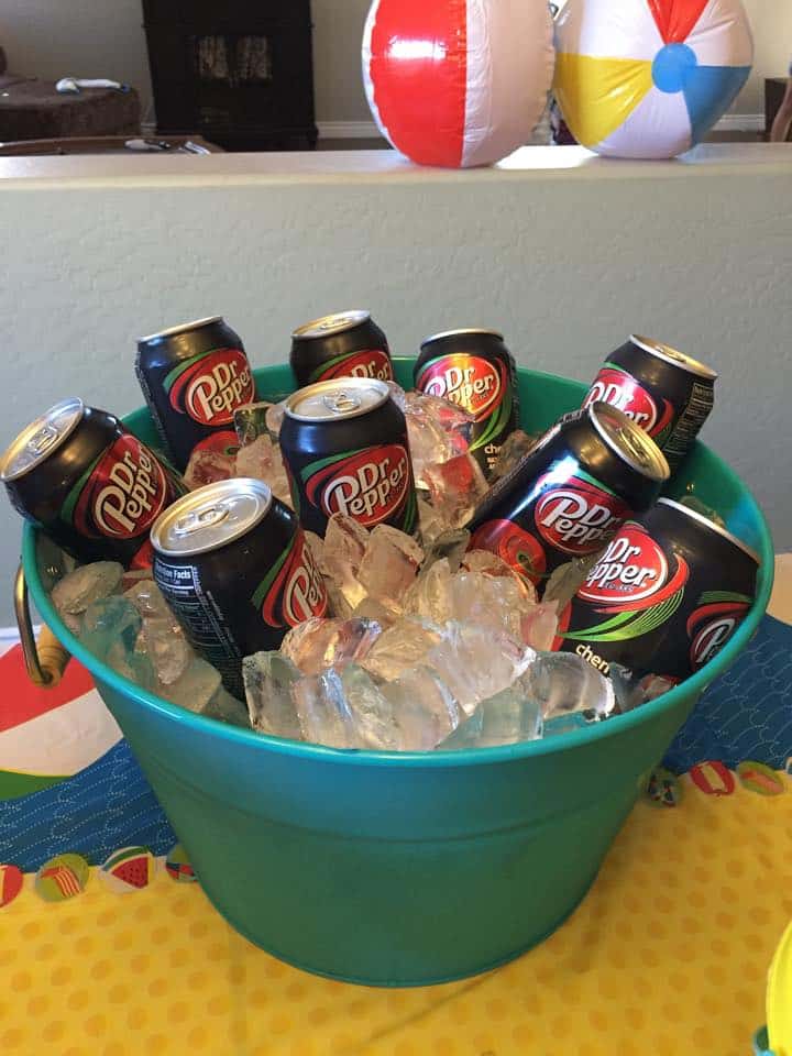 Bucket of ice with cans of dr. pepper