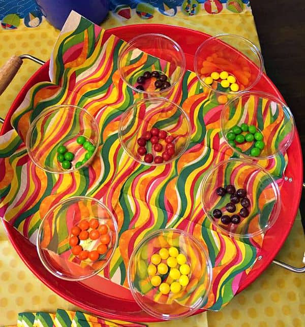 Overhead shot of Skittles in clear cups seperated by color