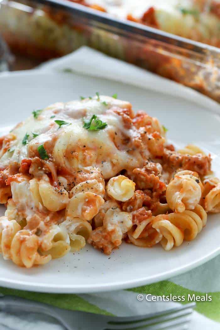 Sour cream noodle bake on a white plate garnished with parsley