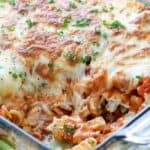 Sour cream noodle bake in a clear casserole dish with a scoop taken out