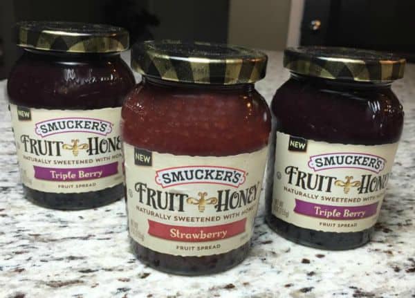 Three jars of Smuckers fruit spread