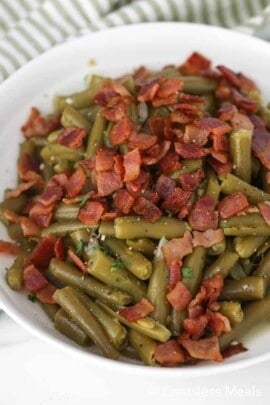 Texas Roadhouse green beans in a white bowl with bacon