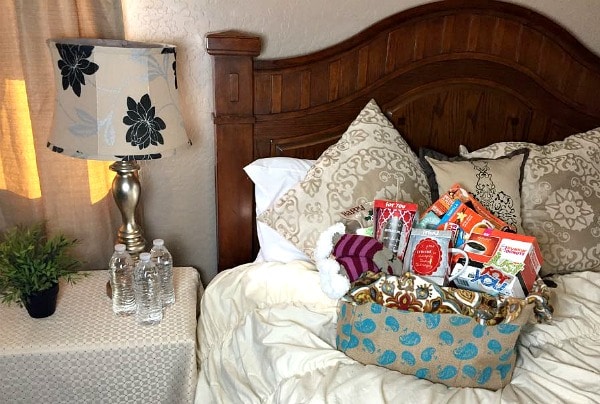 Guest room with basket of gifts on the bed