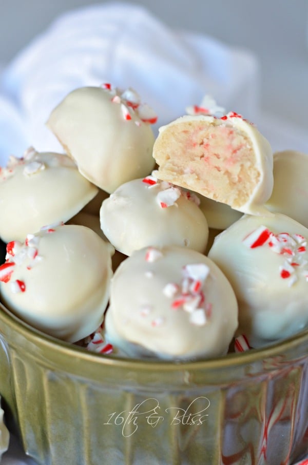 White chocolate peppermint truffles in a dish with one cut in half