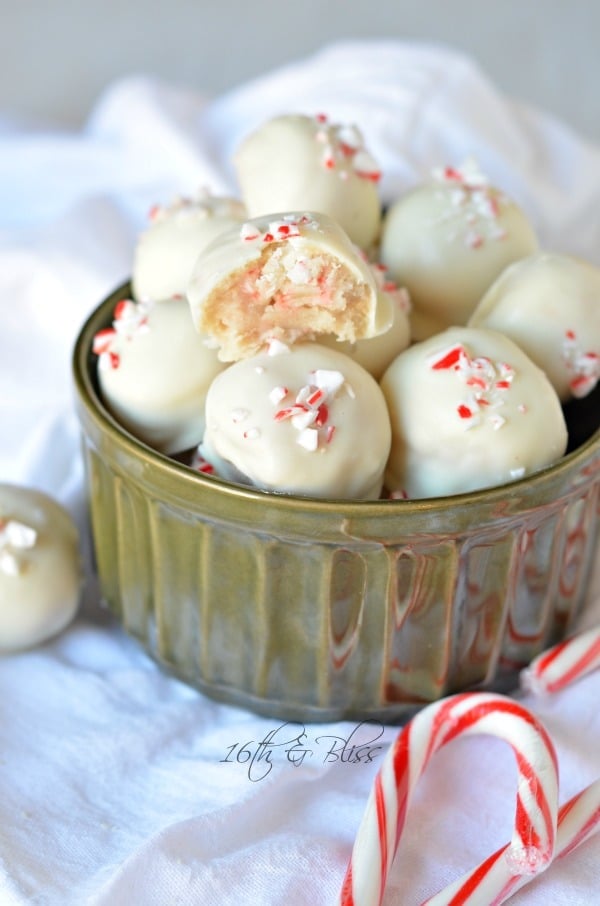 White chocolate peppermint truffles with a bite taken out of 1