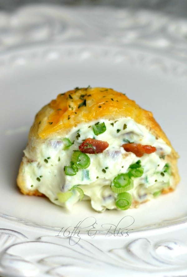 Bacon cream cheese bomb on a white plate garnished with parsley