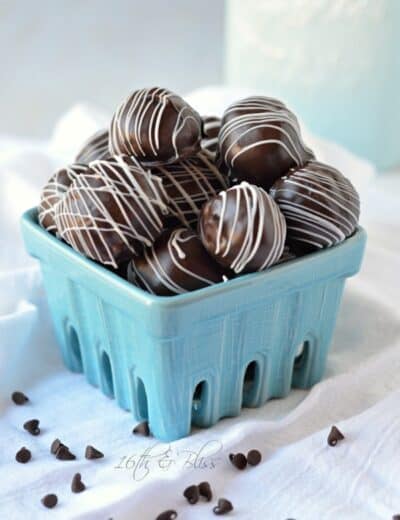 Chocolate chip cookie dough truffles in a dish drizzled with white chocolate