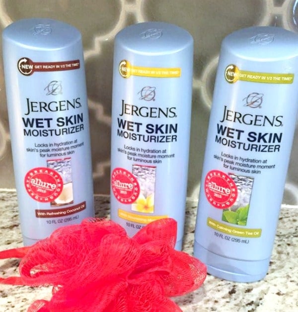 Jergens lotion on the counter with a loofah