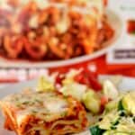 Easy parmesan zucchini on a white plate with lasagna