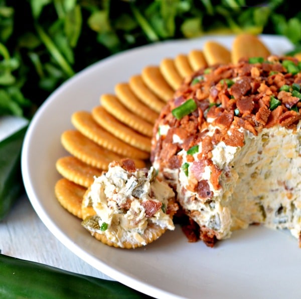 Bacon jalapeno cheese ball on a plate with crackers