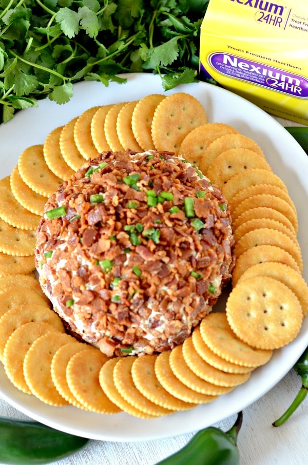 Bacon jalapeno cheese ball on a plate with crackers and heartburn medication