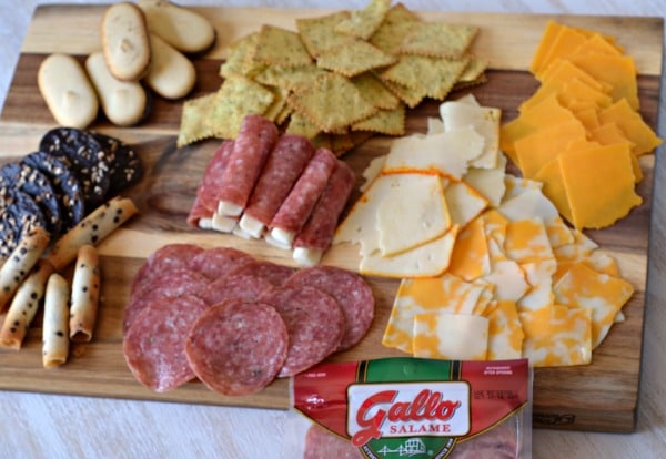 Meat cheese and cracker platter on a wooden board