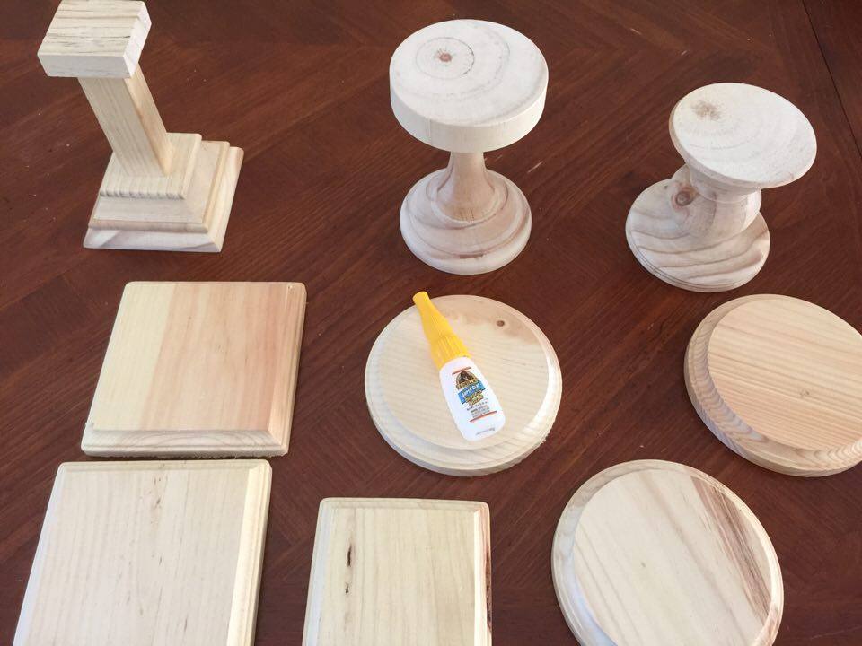 Wooden pieces and glue on a table top for DIY mantle decor