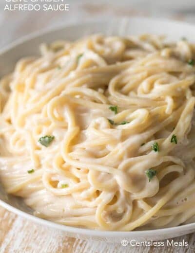 Copycat Olive Garden alfredo sauce with noodles and parsley in a bowl