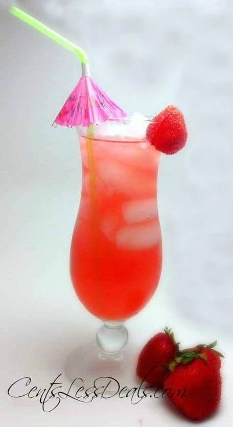 Juicy pineapple drink with strawberry and umbrella as garnish