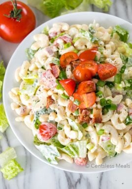 BLT Pasta Salad is a potluck favorite, and loaded with delicious flavors. Tender pasta is tossed with crisp salty bacon, succulent tomatoes and crunchy romaine for a pasta salad your family is going to love! #centslessmeals #easyrecipe #easysalad #pastarecipe #potluck #withlettuce #withbacon #withtomato #easyside