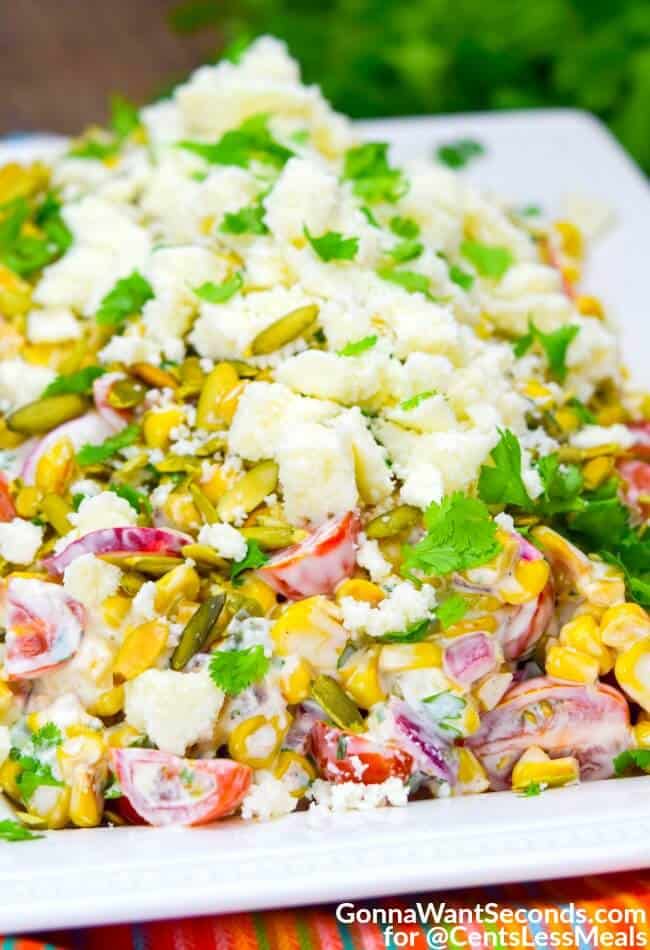 Mexican Corn Salad on a white serving plate with cilantro