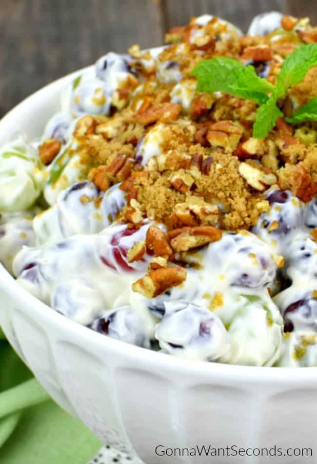 Easy Grape Salad in a bowl garnished with nuts and mint leaves