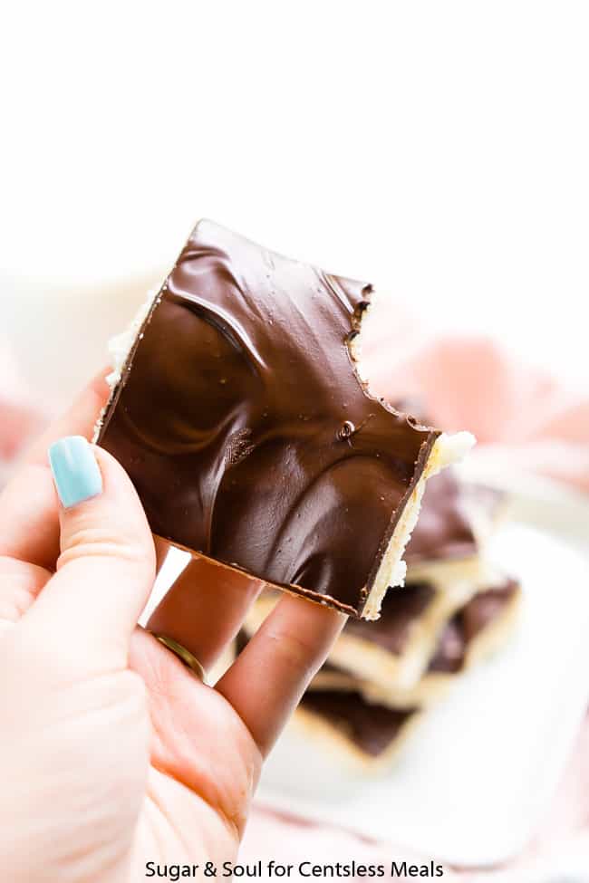 Opera cream candy being held with a bite taken out