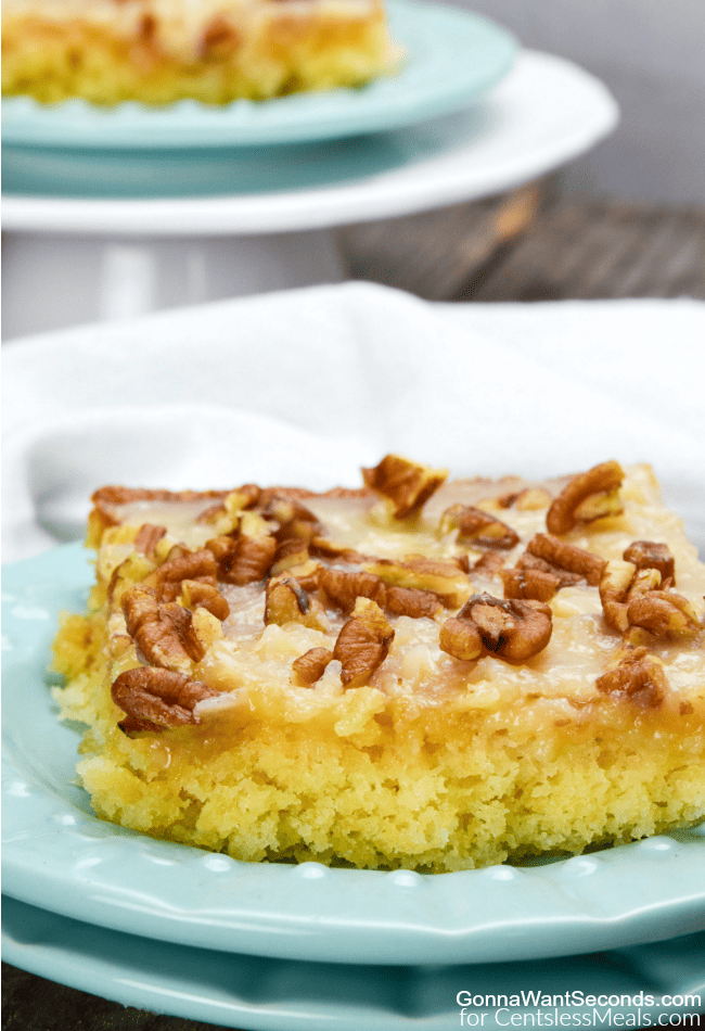 Pineapple Sheet Cake on a blue plate with pecans on top