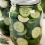 Refrigerator Dill Pickles in a mason jar on a wooden board
