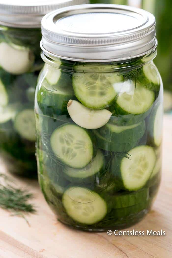 Refrigerator Dill Pickles in a mason jar on a wooden board