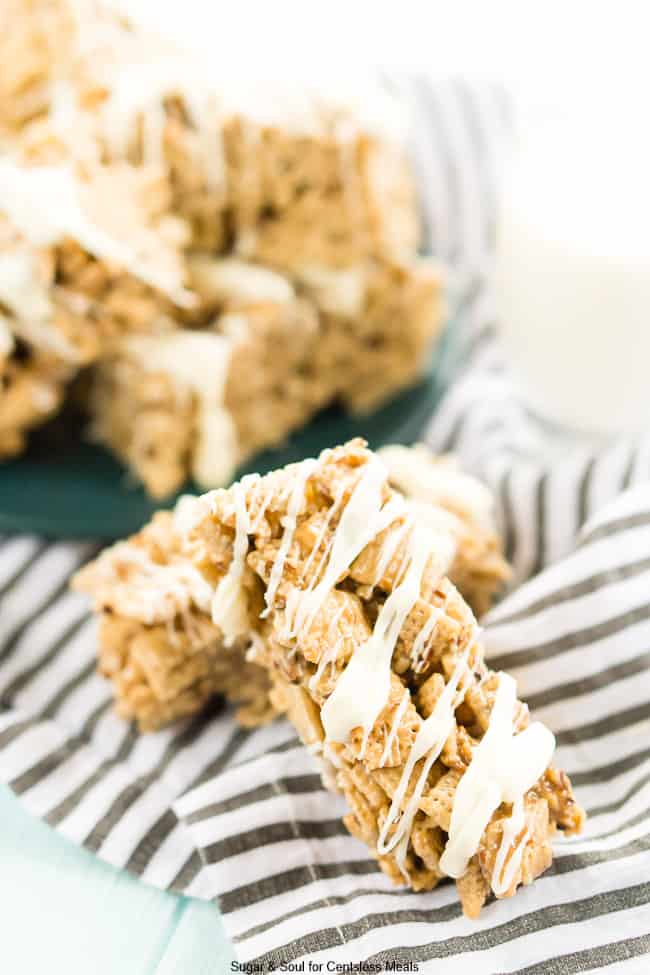 Brown butter pecan cereal bars in a stack on a tea towel