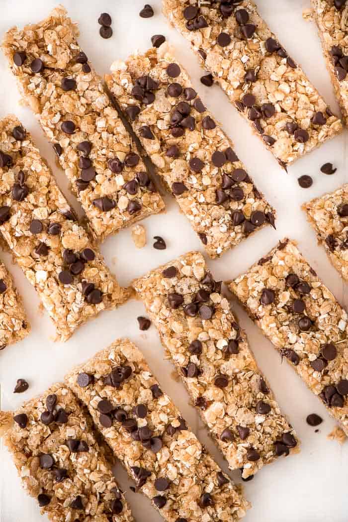 No bake chocolate chip granola bars on parchment paper with chocolate chips on top