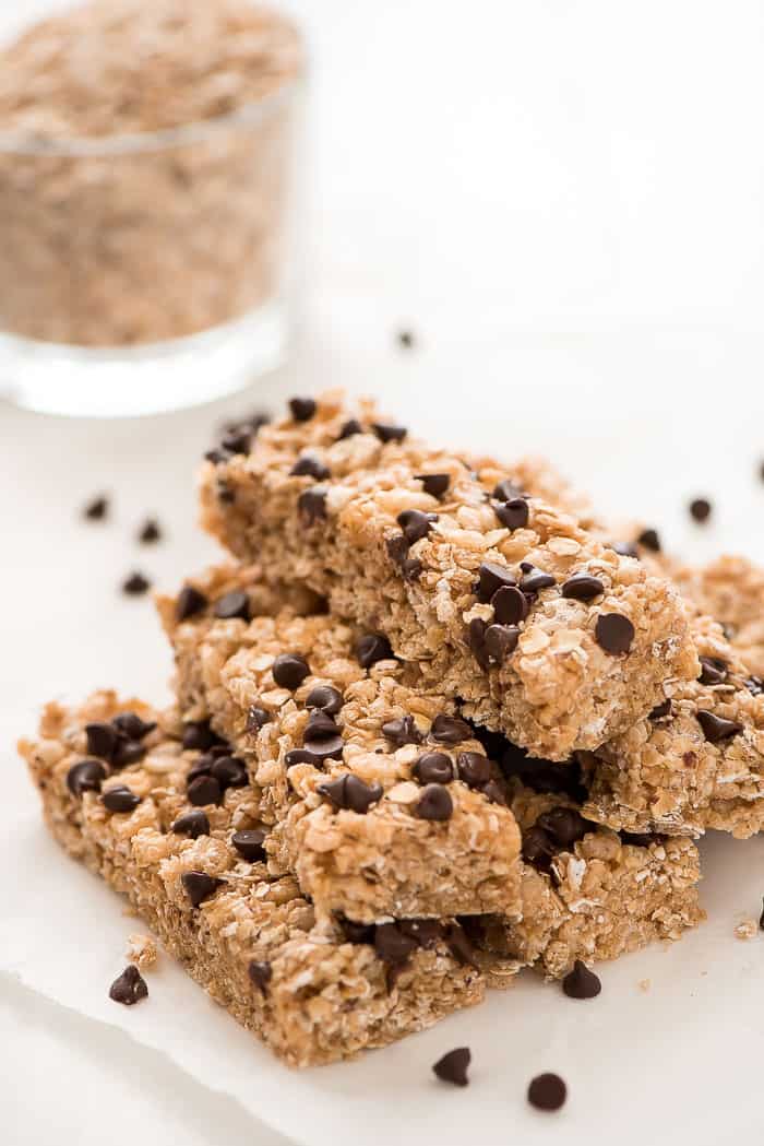 No bake chocolate chip granola bars on parchment paper with chocolate chips