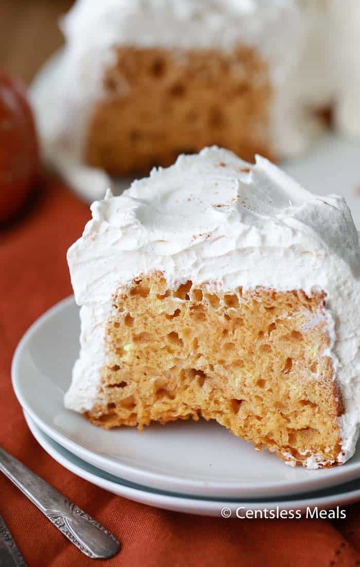 Pumpkin angel food cake on a plate with whipped cream