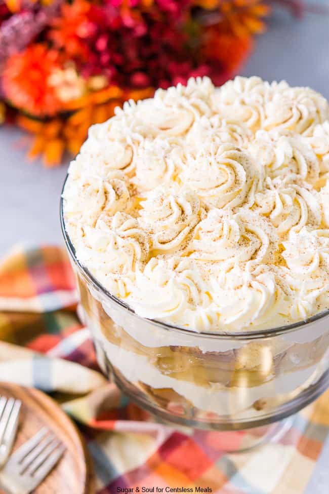 Caramel apple trifle in a trifle dish topped with whipped cream