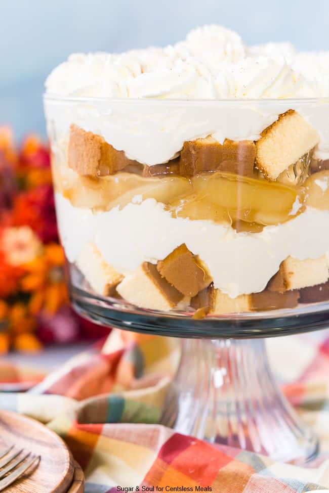 Caramel apple trifle in a trifle dish topped with whipped cream