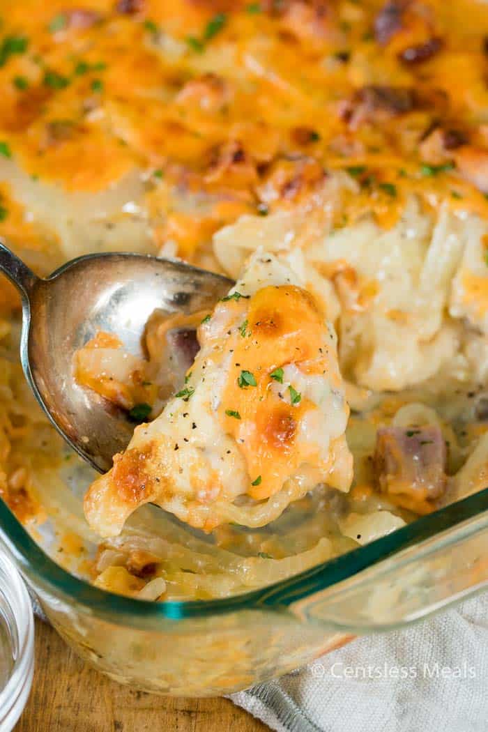Pierogi casserole in a clear dish with some on a spoon
