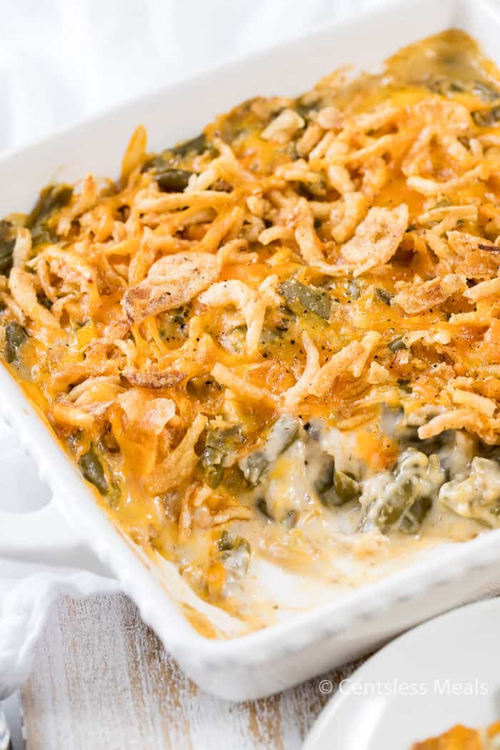 Green bean casserole in a casserole dish with a scoop taken out