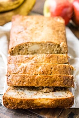 Apple banana bread on a plate with some cut into slices