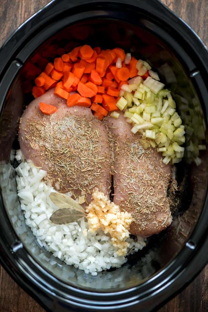 Ingredients for slow cooker chicken wild rice soup in a slow cooker