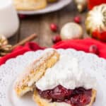 Cranberry Shortcake on a white plate with a glass of milk in the background