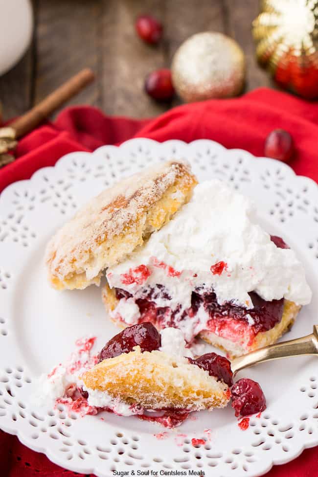 Cranberry Shortcake on a white plate with a gold fork and whipped cream