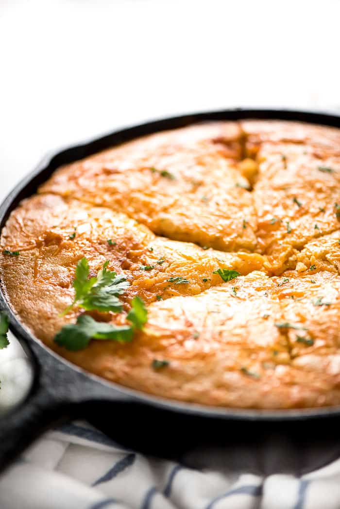 Tamale pie in a pan garnished with cilantro