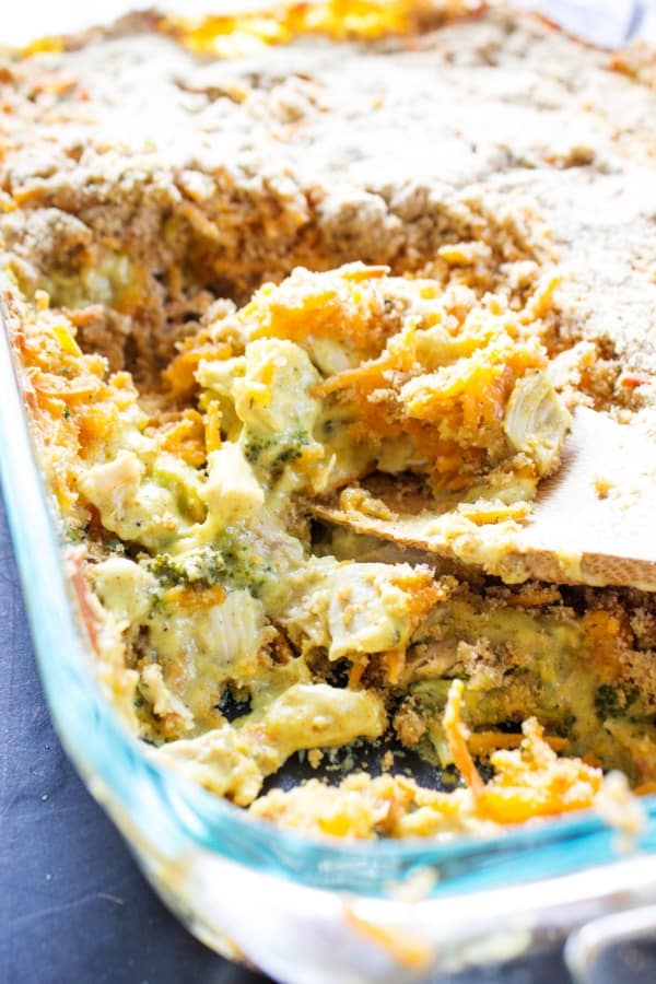 Broccoli Chicken Curry Casserole in a baking dish with a wooden spoon