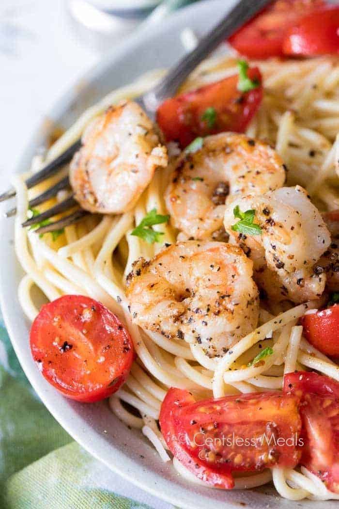 Garlic Shrimp Pasta in a white bowl with a fork