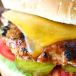 Turkey burger with melted cheese pickles tomatoes and lettuce